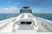 Slide: The Image of 2023 Invincible 46' Catamaran Pilothouse on open sea, clear sky background. - 9