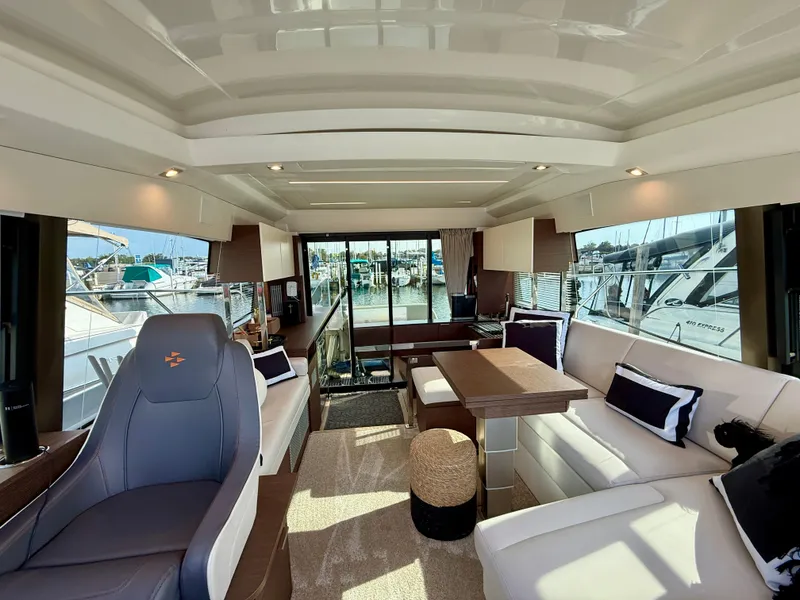 Slide: The Image of Luxurious interior of 2020 Prestige 420S yacht with elegant seating and marina view. - 26
