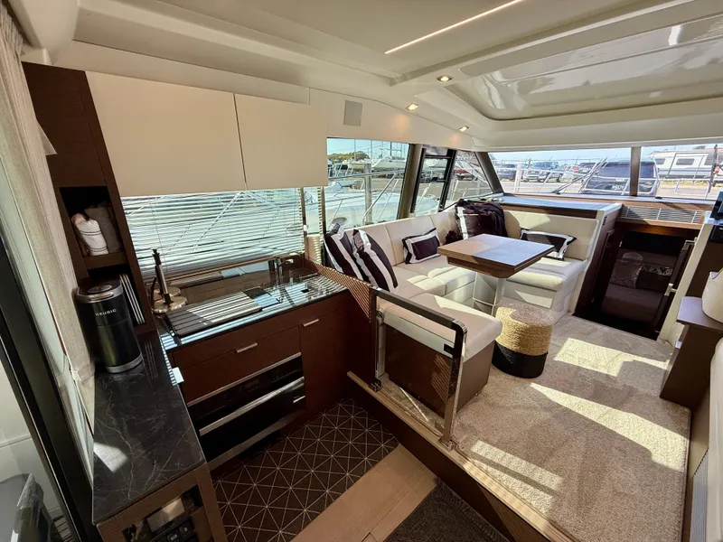 Slide: The Image of Luxurious interior of 2020 Prestige 420S yacht with modern kitchen and seating area. - 28