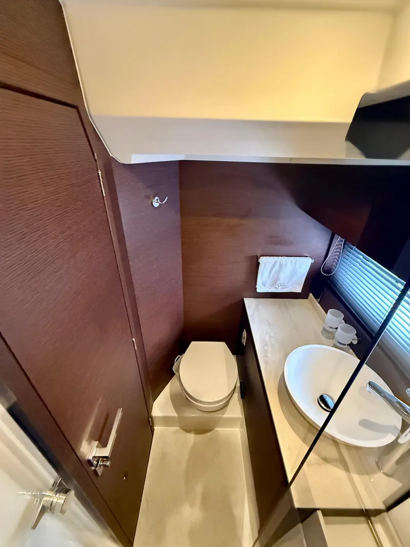 Slide: The Image of Luxurious bathroom in 2020 Prestige 420S yacht with modern fixtures and wooden accents. - 34