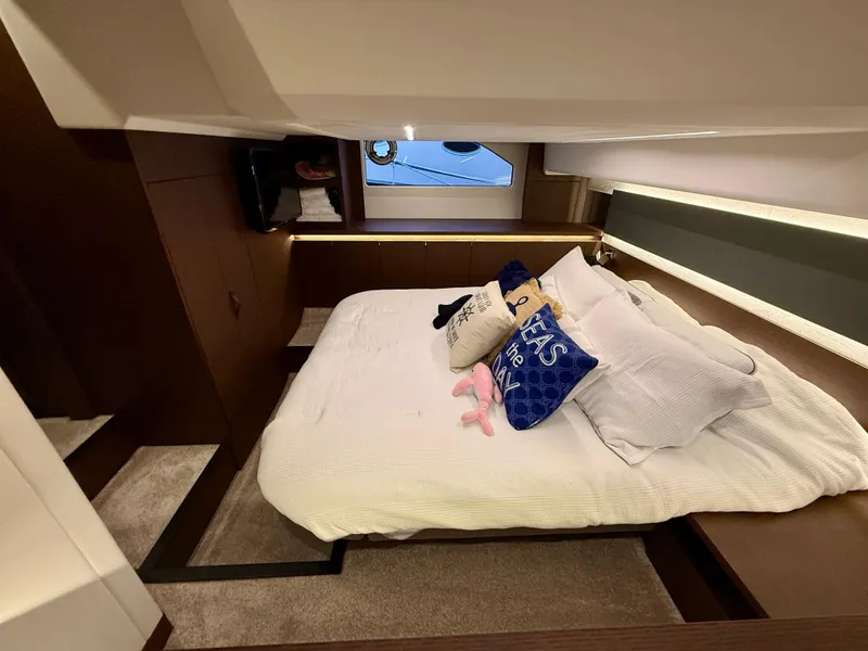 Slide: The Image of Luxurious cabin interior of 2020 Prestige 420S yacht with cozy bed and decorative pillows. - 36