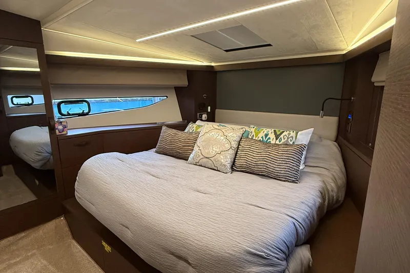 Slide: The Image of Luxurious bedroom interior of 2020 Prestige 420S yacht with elegant bedding and ambient lighting. - 38