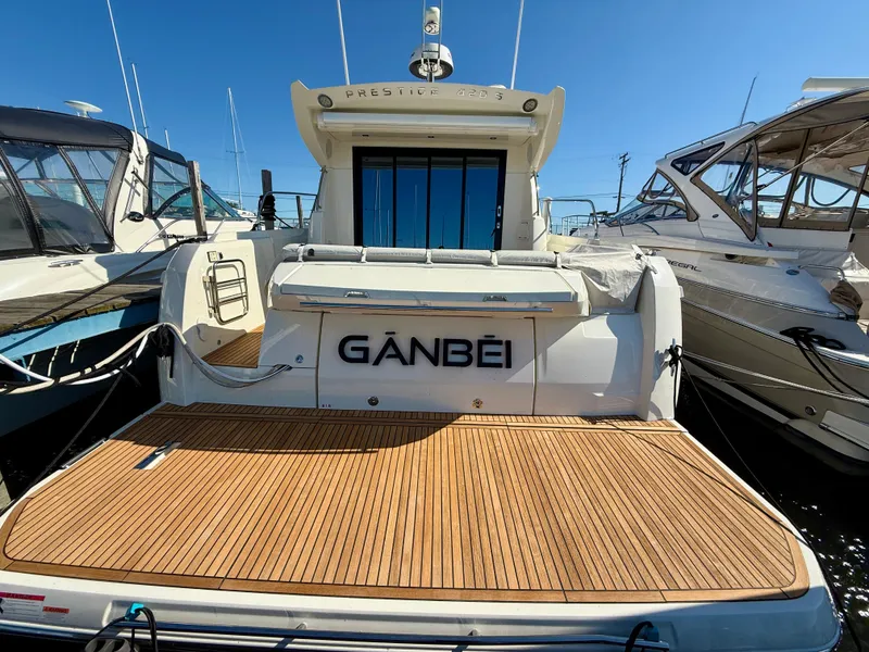 Slide: The Image of 2020 Prestige 420S yacht with teak deck, docked in marina under clear blue sky. - 8