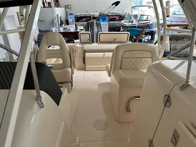 Slide: The Image of Interior of 2024 Grady-White Freedom 235 boat, showcasing seating and helm area. - 2
