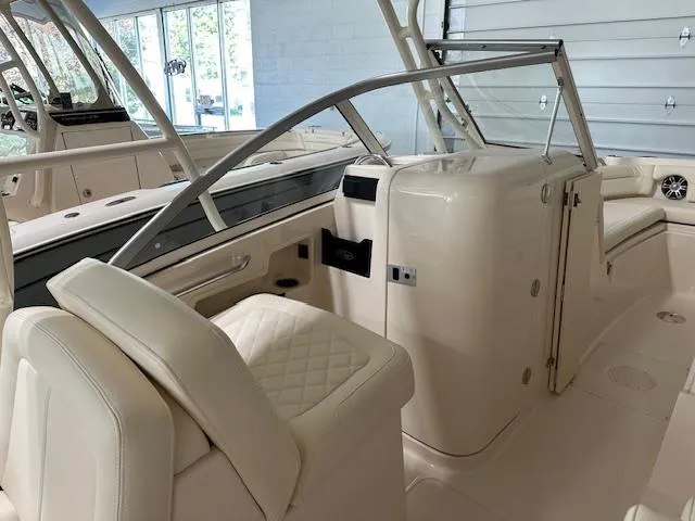 Slide: The Image of 2024 Grady-White Freedom 235 boat interior with luxurious seating and modern design. - 4