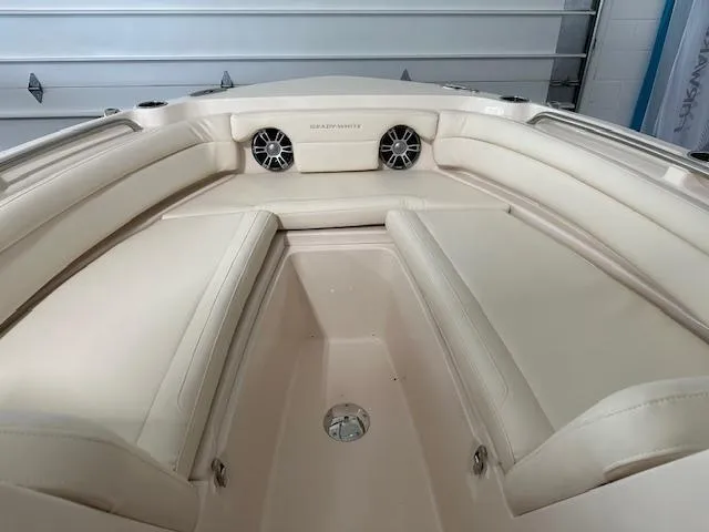 Slide: The Image of 2024 Grady-White Freedom 235 boat interior with beige seating and speakers. - 6