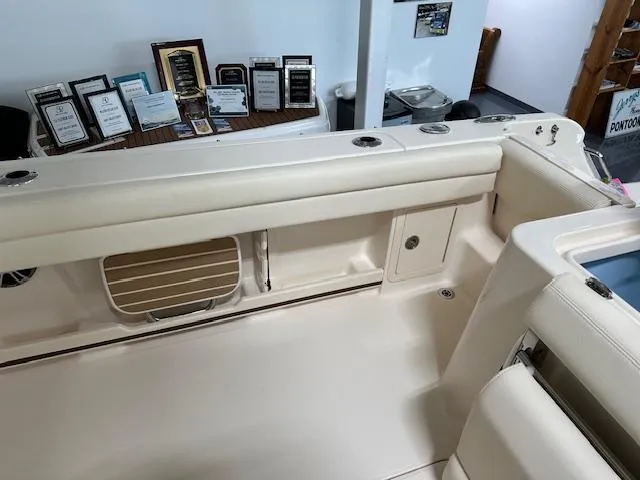 Slide: The Image of 2024 Grady-White Freedom 235 boat interior with awards in the background. - 9