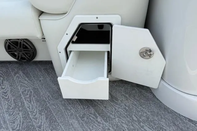 Slide: The Image of Storage compartment with open drawer in 2023 JC Neptoon 23 TT Sport boat interior. - 17
