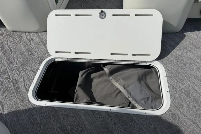 Slide: The Image of Open storage compartment on 2023 JC Neptoon 23 TT Sport boat with bag inside. - 22