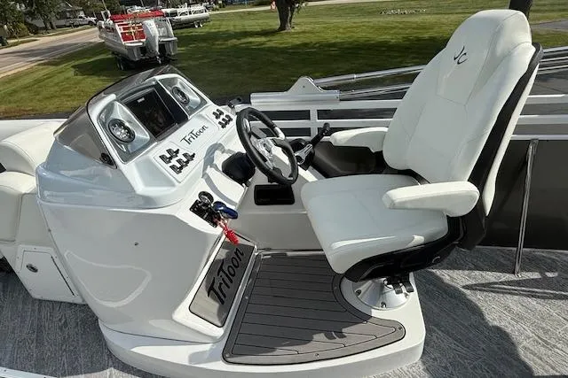 Slide: The Image of 2023 JC Neptoon 23 TT Sport boat cockpit with steering wheel and captain's chair. - 8