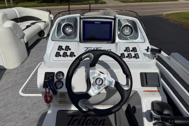 Slide: The Image of 2023 JC Neptoon 23 TT Sport boat dashboard with steering wheel and control panel. - 9