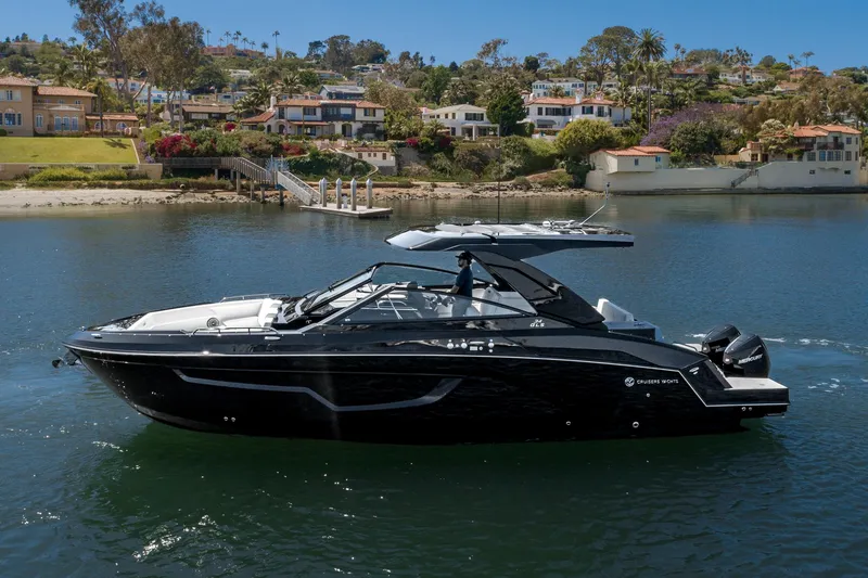 The Image of 2025 Cruisers Yachts 34 GLS on serene water with scenic background. - 0
