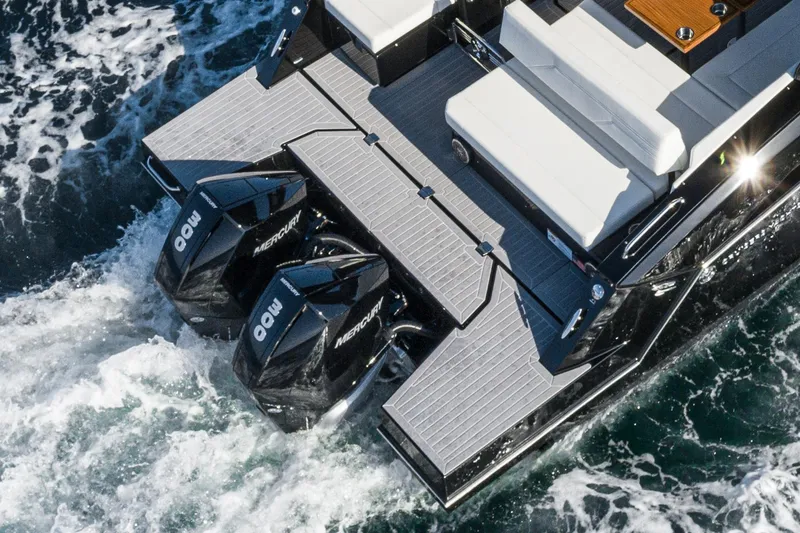 Slide: The Image of 2025 Cruisers Yachts 34 GLS with dual Mercury outboard engines on the water. - 14