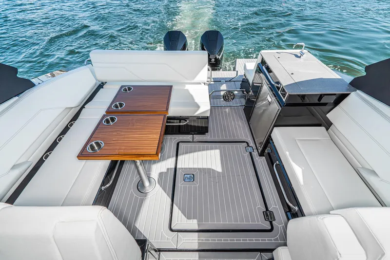 Slide: The Image of 2025 Cruisers Yachts 34 GLS interior with seating, table, and water view. - 16