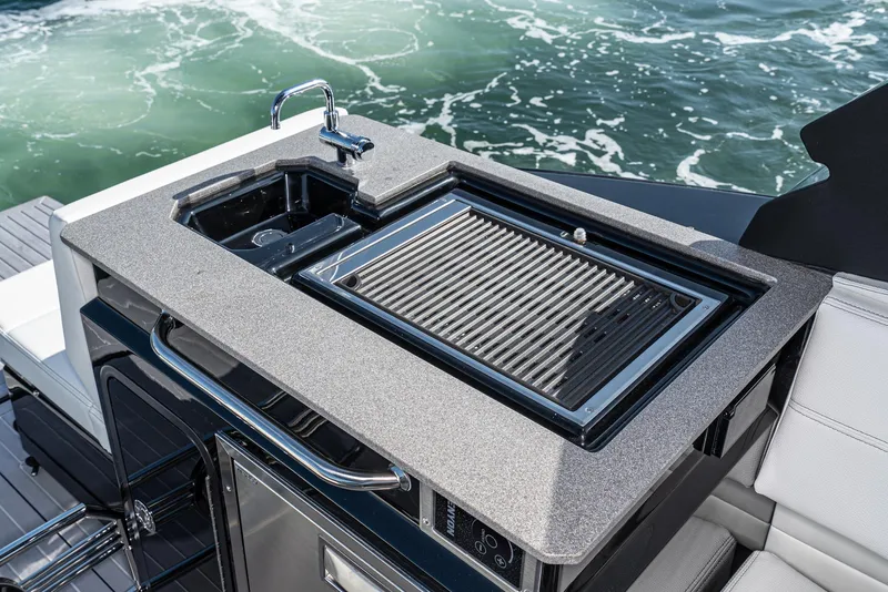 Slide: The Image of 2025 Cruisers Yachts 34 GLS outdoor kitchen with grill and sink on deck. - 24