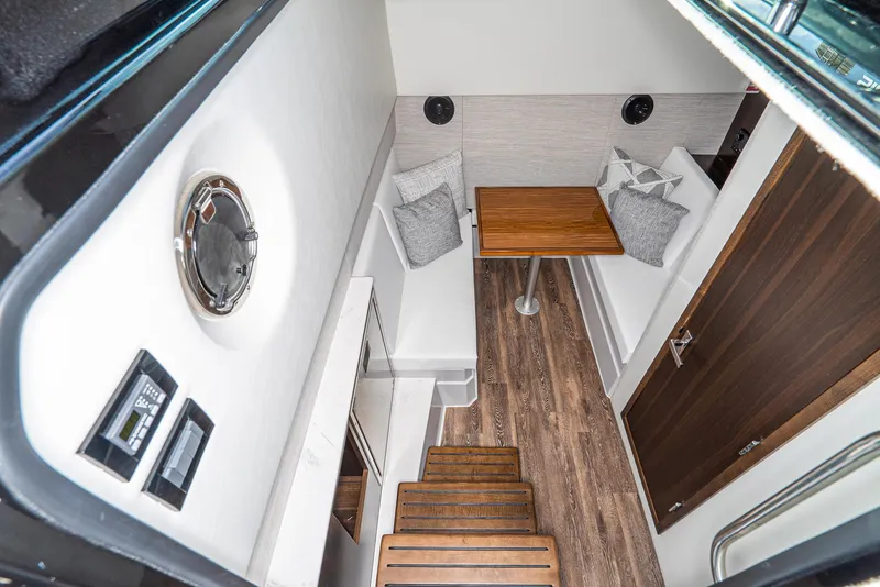 Slide: The Image of Interior of 2025 Cruisers Yachts 34 GLS, featuring cozy seating and wooden flooring. - 28