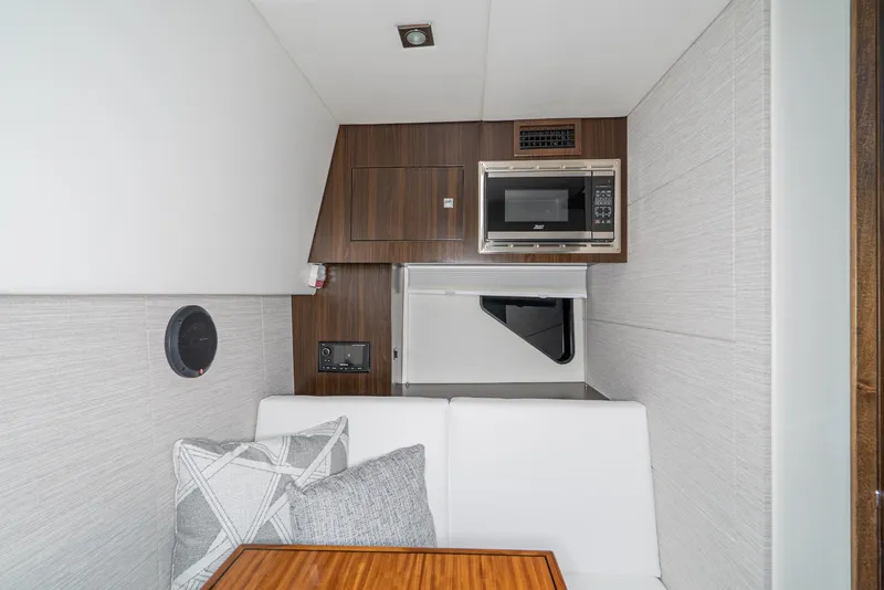 Slide: The Image of Interior of 2025 Cruisers Yachts 34 GLS with modern kitchenette and seating area. - 30