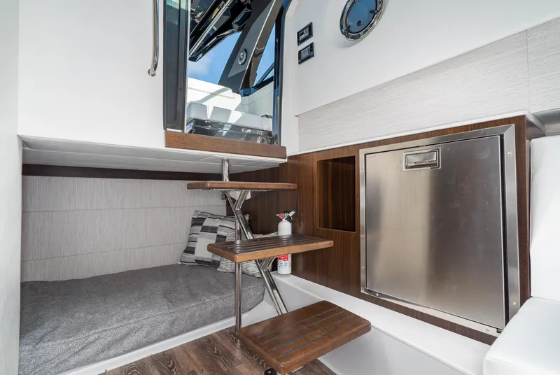 Slide: The Image of Interior of 2025 Cruisers Yachts 34 GLS, featuring modern design and compact sleeping area. - 32
