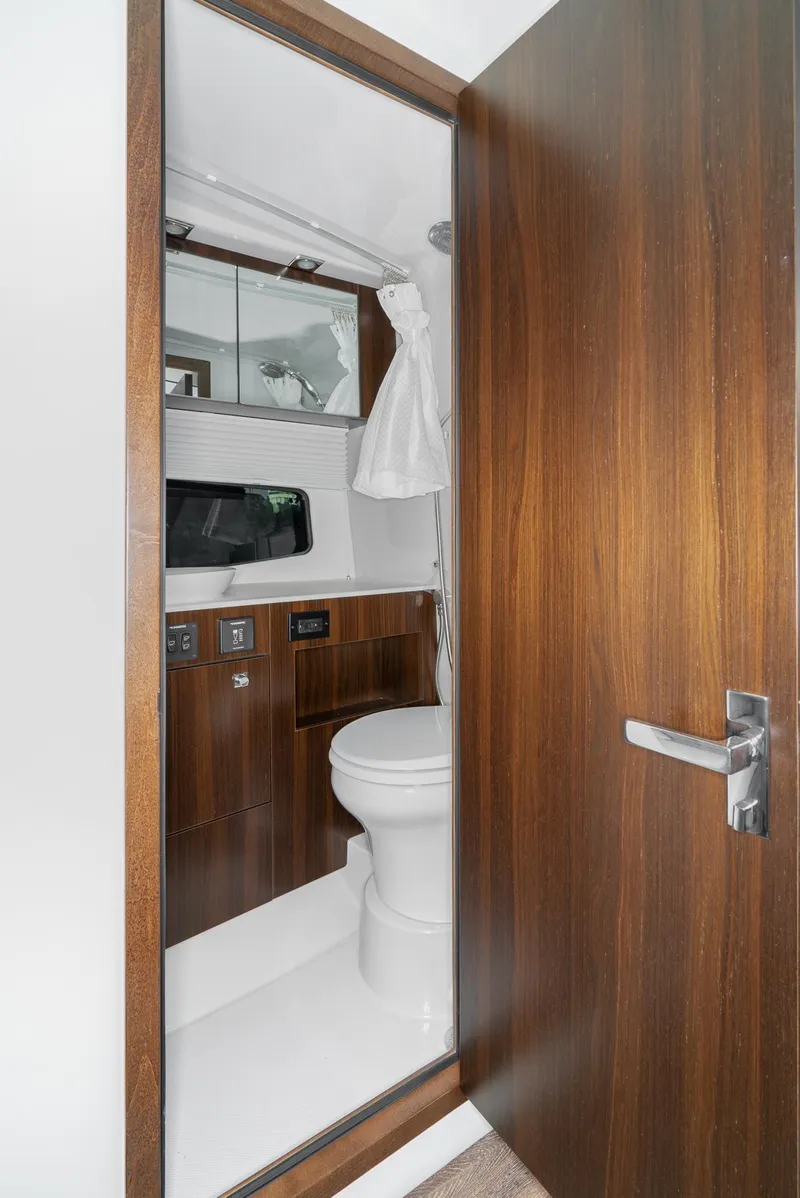 Slide: The Image of Luxurious bathroom in 2025 Cruisers Yachts 34 GLS with modern wood finish. - 36