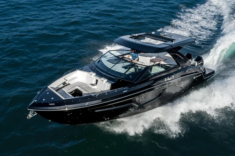 Slide: The Image of 2025 Cruisers Yachts 34 GLS speeding on open water, showcasing sleek design and luxury. - 5