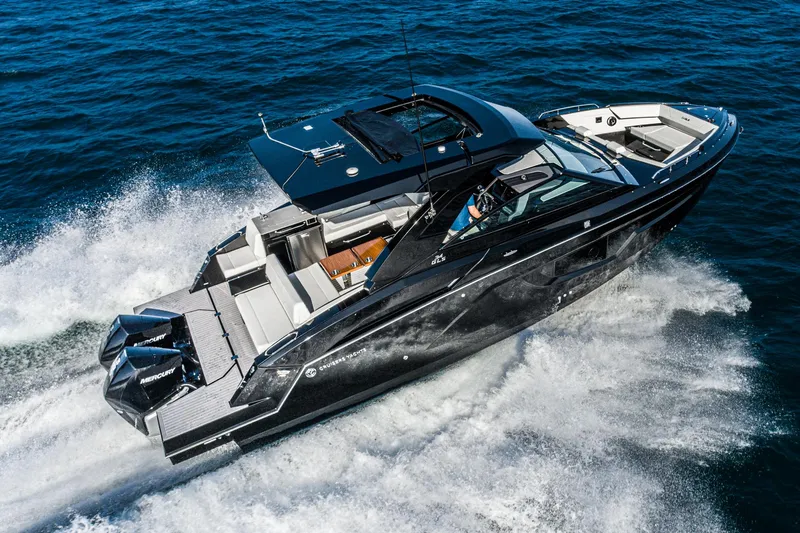 Slide: The Image of 2025 Cruisers Yachts 34 GLS speeding on open water, showcasing sleek design and powerful engines. - 6