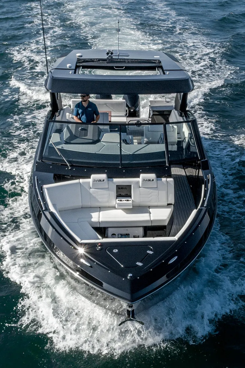 Slide: The Image of 2025 Cruisers Yachts 34 GLS cruising on open water, aerial view. - 8