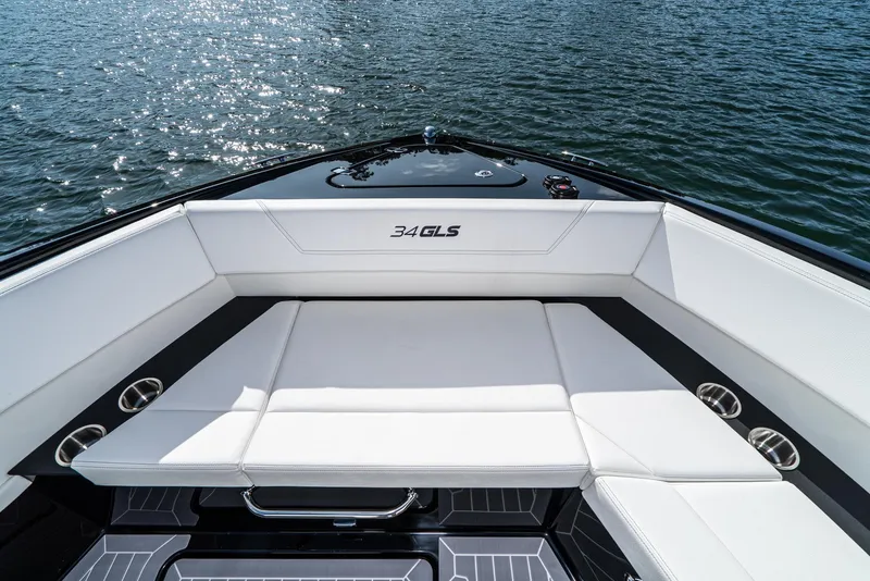 Slide: The Image of 2025 Cruisers Yachts 34 GLS boat interior with white seating and water view. - 10