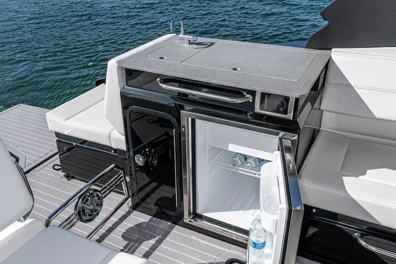 Slide: The Image of 2025 Cruisers Yachts 34 GLS boat interior with mini fridge and seating. - 23