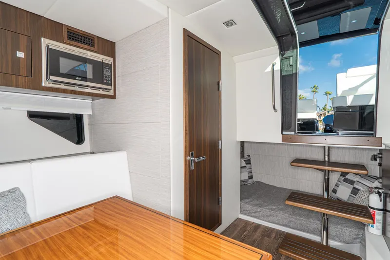Slide: The Image of 2025 Cruisers Yachts 34 GLS interior with modern kitchen and cozy seating area. - 31