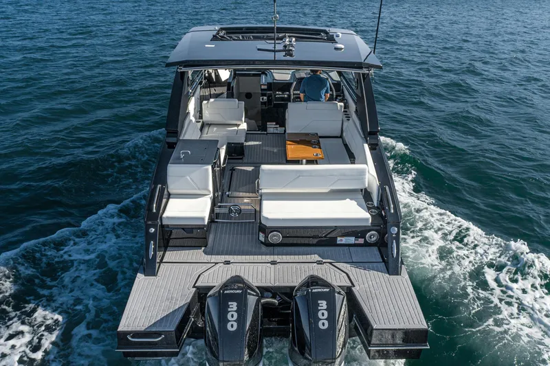 Slide: The Image of 2025 Cruisers Yachts 34 GLS on water, rear view, dual engines, luxury seating. - 38