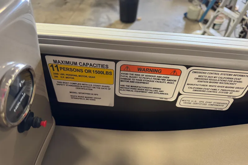 Slide: The Image of 2023 Sun Tracker SportFish 22 XP3 capacity label, warning, and emissions information. - 12