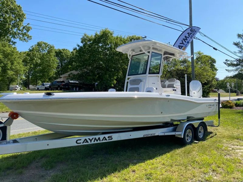 Slide: The Image of 2023 Caymas 26 HB boat on a trailer, displayed outdoors. - 1