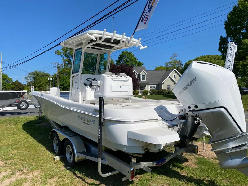 Slide: The Image of 2023 Caymas 26 HB boat on trailer with Mercury outboard motor. - 11