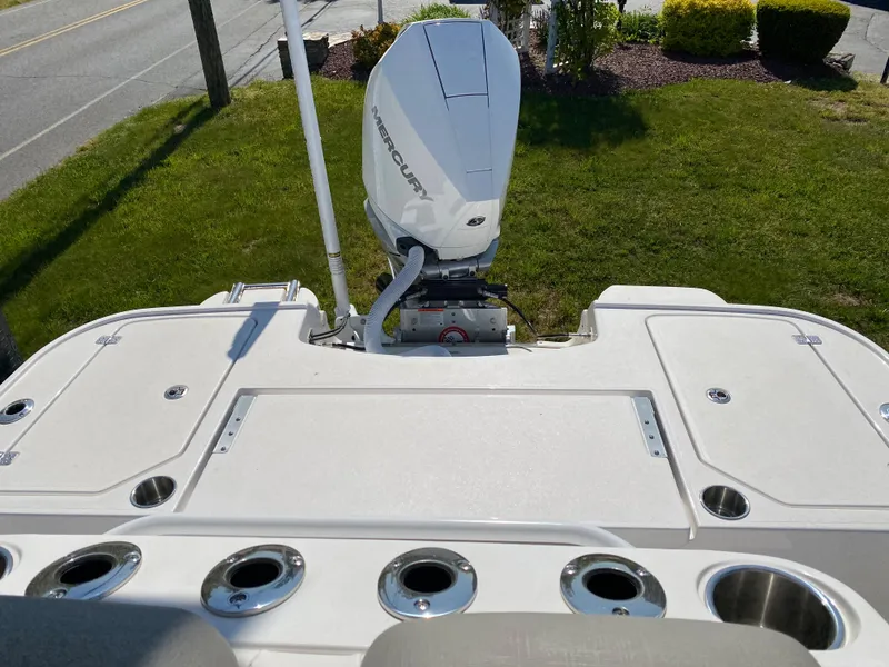 Slide: The Image of 2023 Caymas 26 HB boat with Mercury outboard motor, rear deck view. - 4