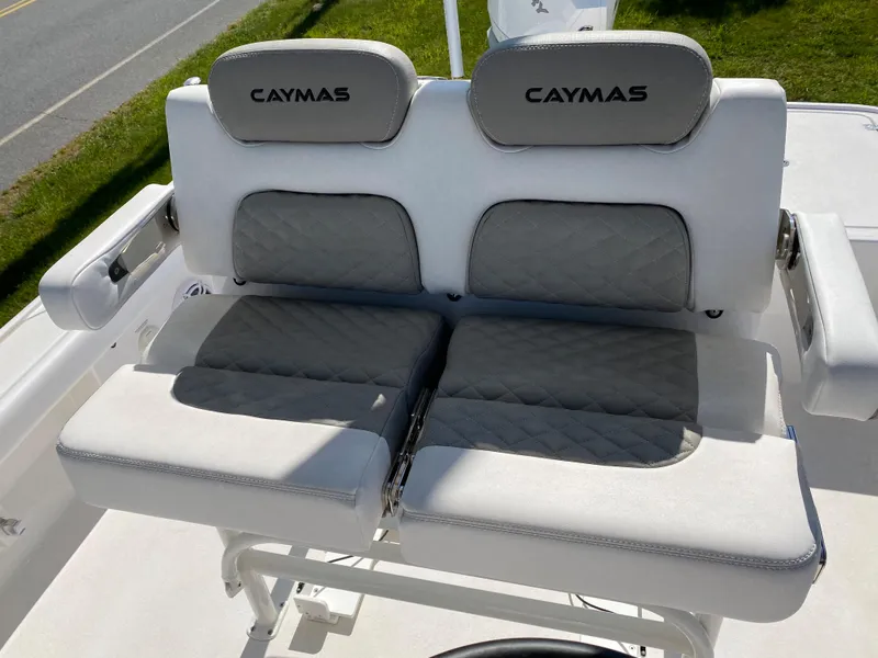 Slide: The Image of 2023 Caymas 26 HB boat seating with cushioned backrests and armrests. - 5