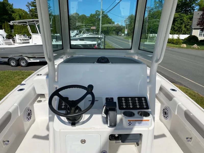 Slide: The Image of 2023 Caymas 26 HB boat helm with steering wheel and control panel. - 6