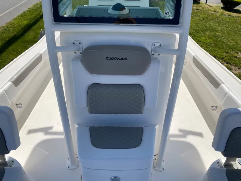 Slide: The Image of 2023 Caymas 26 HB boat interior with cushioned seating and console. - 7