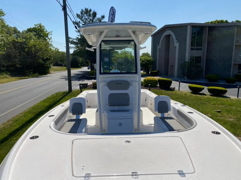 Slide: The Image of 2023 Caymas 26 HB boat on display outdoors. - 9