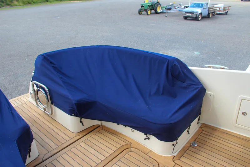 Slide: The Image of 2017 Chris-Craft Launch 36 boat with blue-covered seating on teak deck. - 21