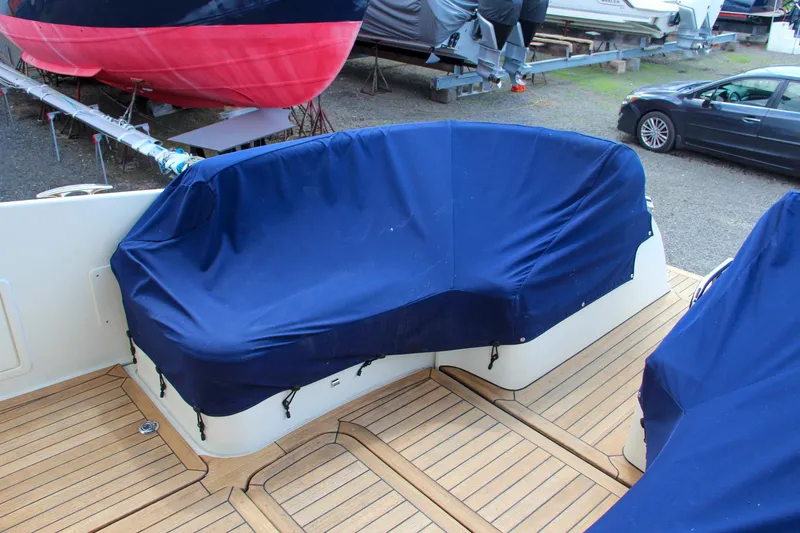 Slide: The Image of 2017 Chris-Craft Launch 36 boat with blue covered seating on teak deck. - 22