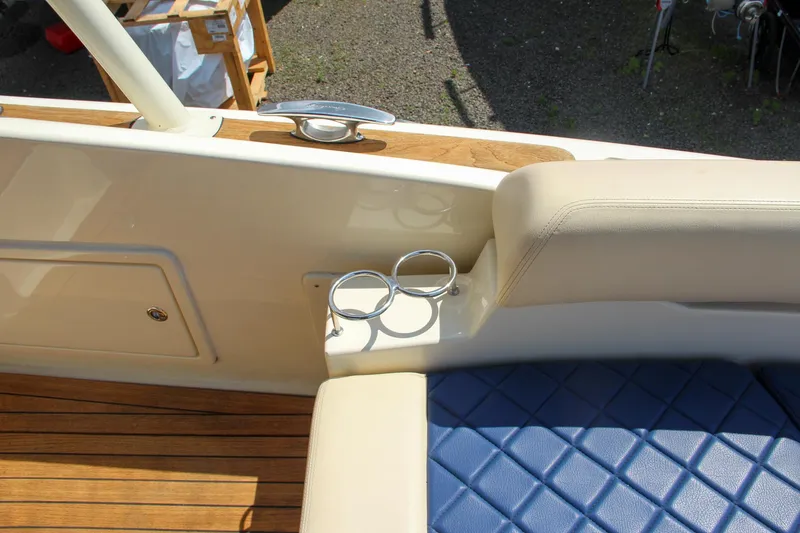 Slide: The Image of 2017 Chris-Craft Launch 36 interior with blue diamond-stitched seating and cup holders. - 24