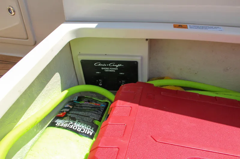 Slide: The Image of Storage compartment of a 2017 Chris-Craft Launch 36 boat with shore power panel. - 28
