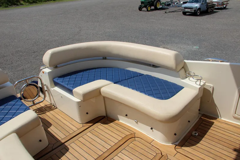 Slide: The Image of 2017 Chris-Craft Launch 36 boat with blue and beige seating on teak deck. - 29