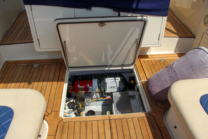 Slide: The Image of 2017 Chris-Craft Launch 36 engine compartment with open hatch on teak deck. - 33