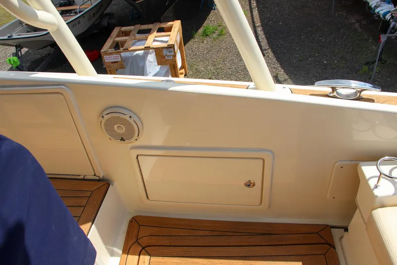 Slide: The Image of Interior view of 2017 Chris-Craft Launch 36 boat with teak flooring and storage compartment. - 36