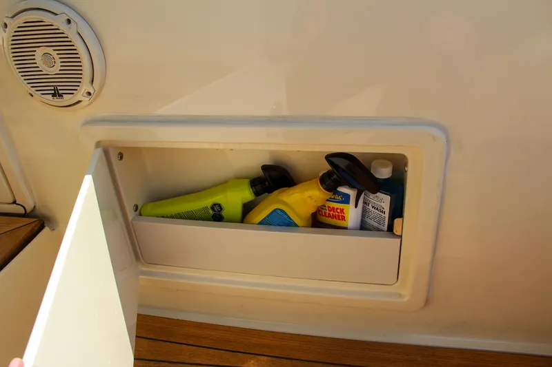 Slide: The Image of Storage compartment on 2017 Chris-Craft Launch 36 with cleaning supplies. - 37