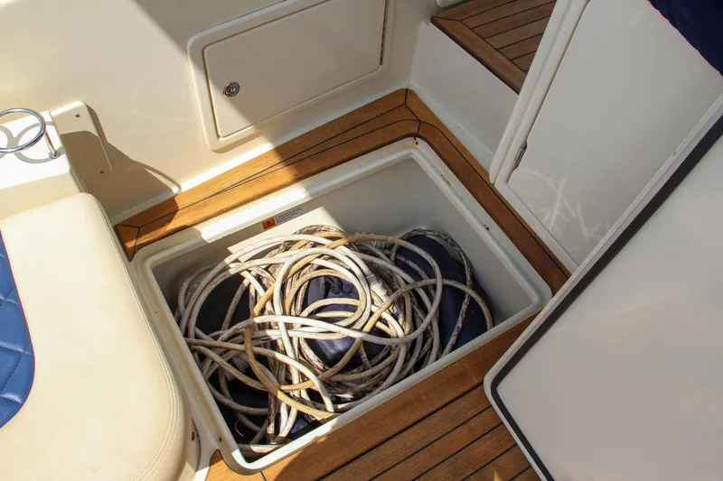 Slide: The Image of 2017 Chris-Craft Launch 36 storage compartment with coiled ropes on teak deck. - 39
