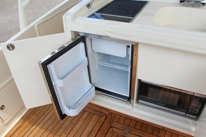 Slide: The Image of 2017 Chris-Craft Launch 36 boat kitchen with open fridge and microwave. - 48