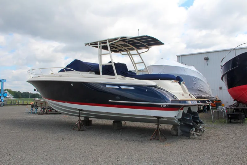Slide: The Image of 2017 Chris-Craft Launch 36 boat on dry dock, black hull with red stripe. - 9