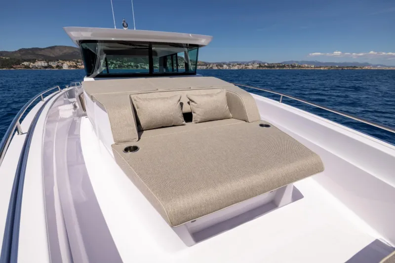 Slide: The Image of 2024 Axopar 45 boat with sunbed on deck, cruising on a clear blue sea. - 4